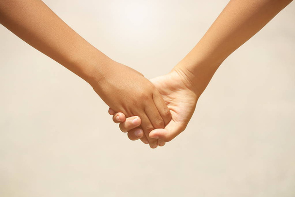 Holding hands with love and tie on a blurred background. - Foto, Imagem
