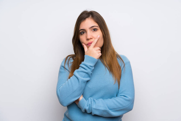 Young girl with blue sweater standing and thinking an idea - Foto, Bild