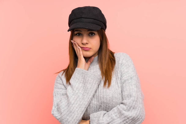 Fashion woman with hat over pink wall unhappy and frustrated - Photo, Image