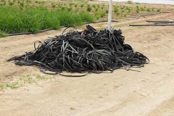 Pile of abandoned tapes for drip irrigation deteriorated, ready to be discarded. - Photo, Image