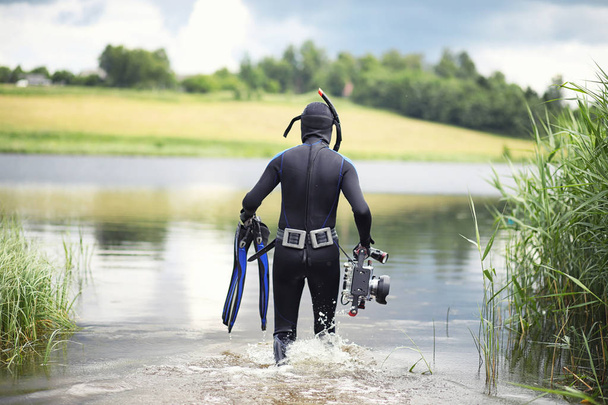 A scuba diver in a wet suit prepares - Photo, Image