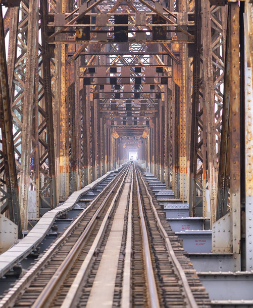 Vintage railroad tracks leading over the famous Long Bien Bridge, Hanoi, Vietnam. This is the railway line was built so long and still in operation today - Photo, Image