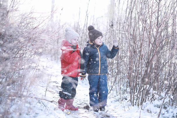 Kids walk in the park first snow - Photo, image