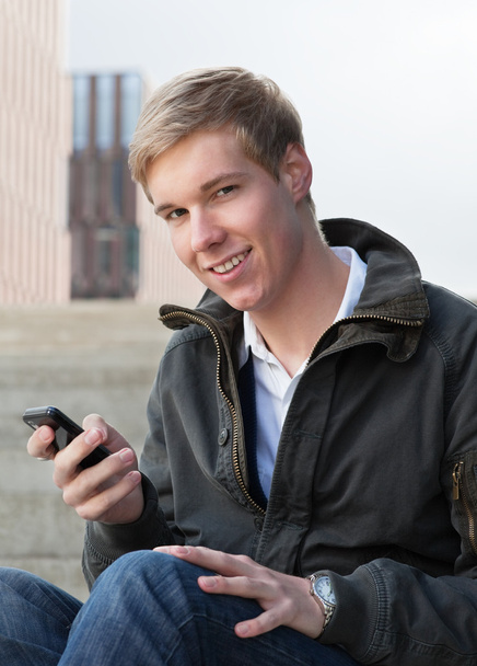 Young guy with cellphone - Valokuva, kuva