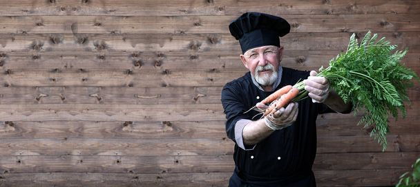 Chef old in uniform with vegetables - Photo, Image