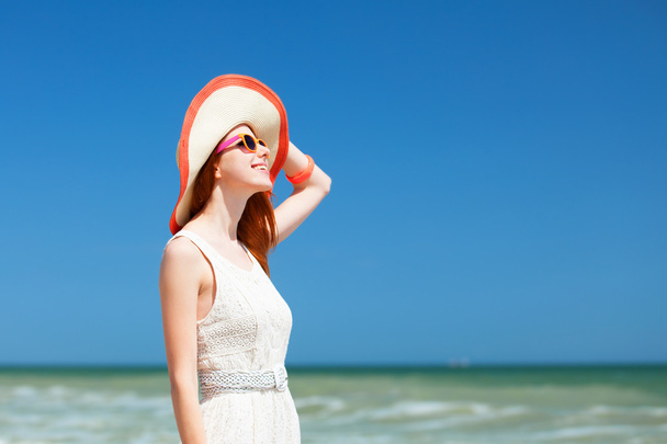 Redhead girl on the beach in spring time. - Foto, Imagem