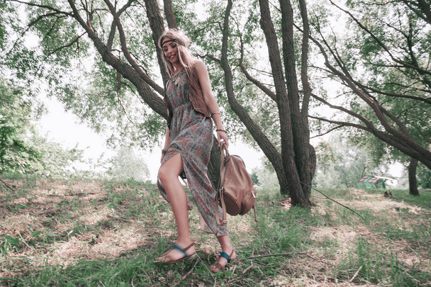 young hippie woman enjoying a walk in spring forest - Foto, Bild