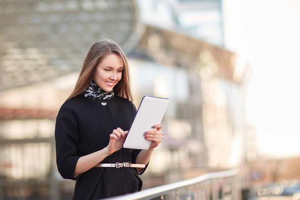 businesswoman with a digital tablet, standing near the business center - Fotoğraf, Görsel
