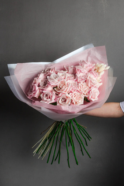 lush bouquet of pink roses in the hands of the girl, fresh flowers, handmade - Fotografie, Obrázek