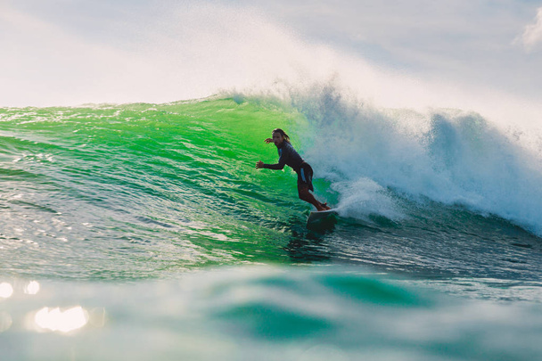 April 24, 2019. Bali, Indonesia. Surfer ride on barrel wave. Professional surfing at Dreamland beach - Zdjęcie, obraz
