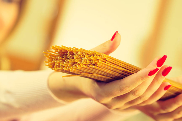 Woman holding long pasta - Photo, image