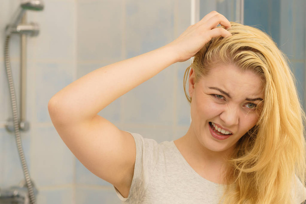 Female having problem with blonde hair - Fotografie, Obrázek