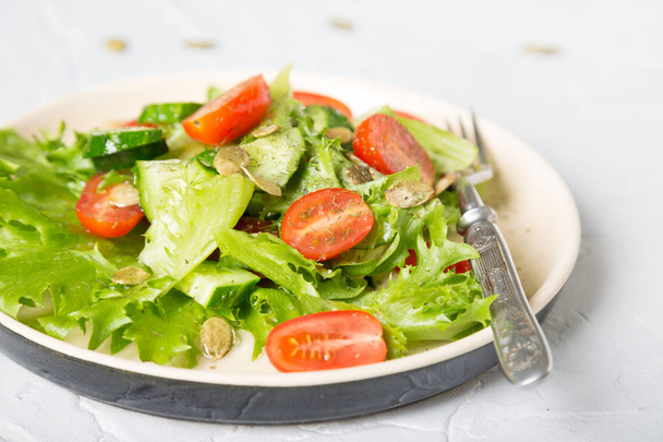 Simple vegetable salad on a light background - Photo, image