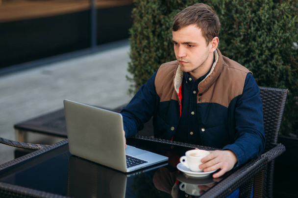 Broker work on his laptop in cafe. Man use his brain to earn money - Fotografie, Obrázek