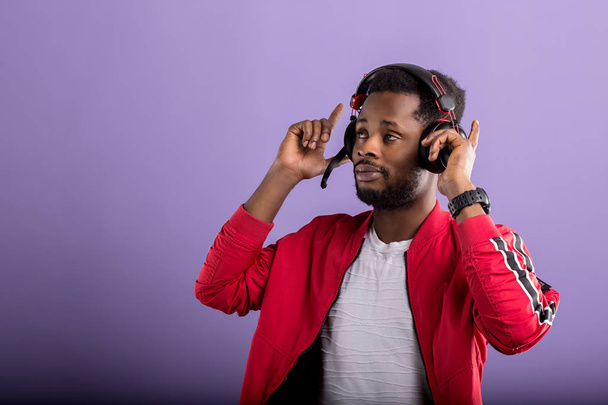 Portrait of young african man listening to music with headphones - Photo, Image
