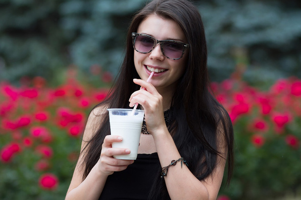 Teen girl with a milkshake on summer day - Foto, immagini