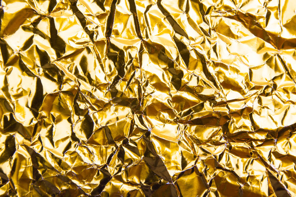 Gold crumpled foil paper texture background. - Fotografie, Obrázek