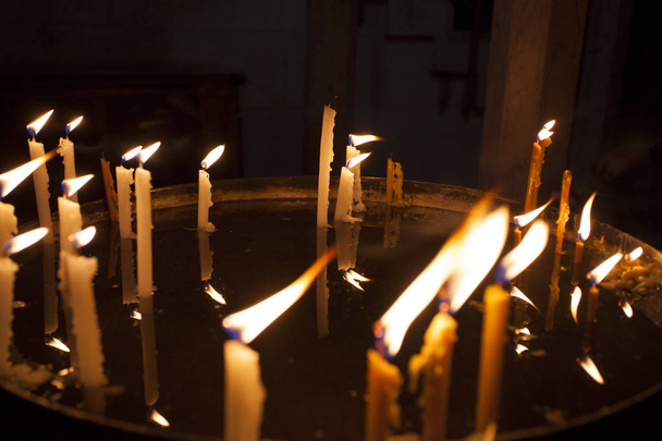 Candles light in the holy sepulchre cathedral in Jerusalem - Фото, зображення