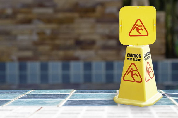 Πλάκες προειδοποίησης βρεγμένο δάπεδο δίπλα στην πισίνα. - Φωτογραφία, εικόνα