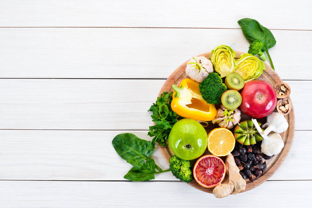 Food containing natural vitamin C: Orange, lemon, apple, rose, garlic, broccoli, apple, kiwi, spinach. Top view. On a white background. - Fotó, kép