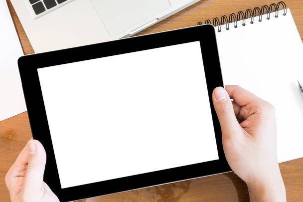 A man is holding a tablet with white blank screen, top view. - Photo, image