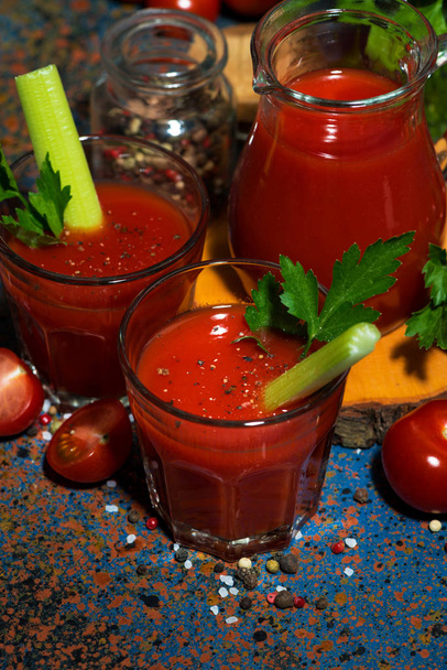 fresh tomato juice with celery in glass cups, vertical top view - Zdjęcie, obraz