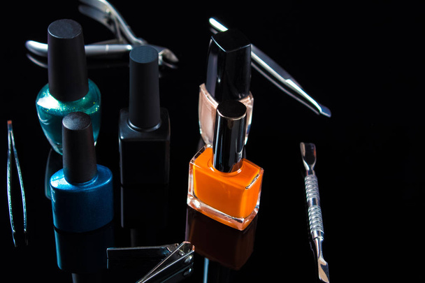Manicure and pedicure tools on black background, isolated. Equipment for beauty shop, cosmetic salon or beauty parlour. Manicure tools in the beauty salon. Equipment for manicure or pedicure salon. - Photo, Image