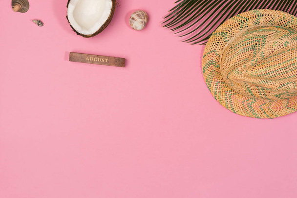 coconut, palm leaf, hat,  on a pink background, top view - Fotoğraf, Görsel
