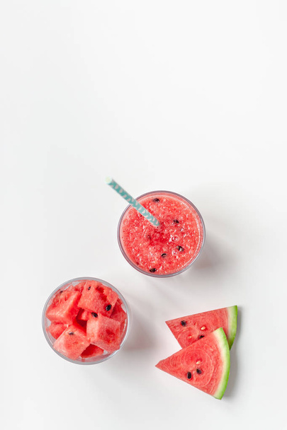Watermelon smoothie with crushed fruits in glasses - Фото, зображення