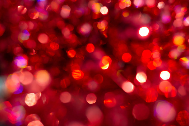 Background blur textures of bokeh, violet, yellow, pink, six sides, round. Defocused abstract red Christmas backdrop. Happy Merry Christmas and New year. - Photo, Image