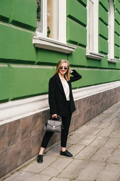 A young girl in a classic suit. Business topics - Valokuva, kuva