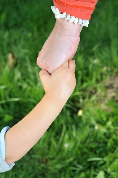 Grandmother holds childs hand - Photo, Image