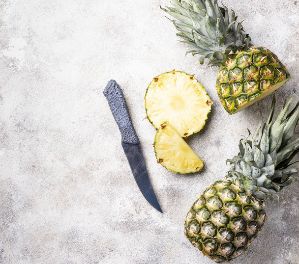 Sliced pineapple on white table - Foto, Imagen