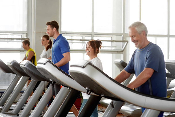 People working out on a treadmill running track. - Photo, Image