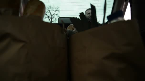Car View Of Family Unloading Food Groceries Bags From Car Trunk. - Filmagem, Vídeo
