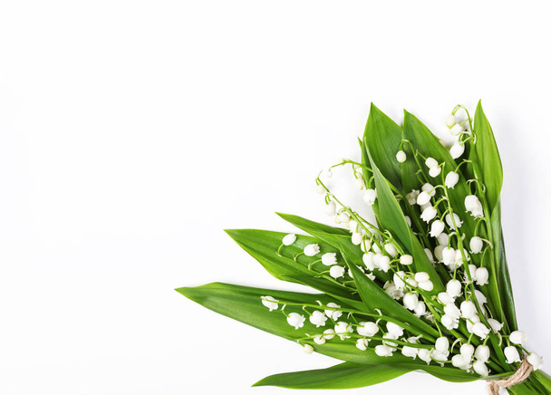 Beautiful bouquet of lilies of the valley isolated on white background. Top view with copy space. Flat lay - Photo, Image