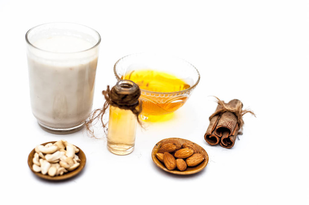 milk, oil, honey, nuts and spices isolated on white background - Foto, Bild