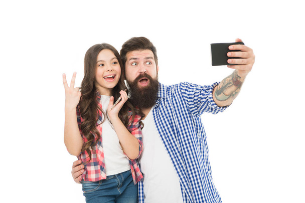 Selfie with dad. fathers day. childrens day. family bonds. having fun together. little child love dad. happy little girl with father use smartphone. father and daughter make photo on smartphone - Foto, afbeelding