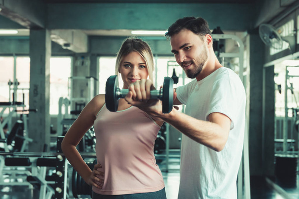 Portrait of Couple Love in Fitness Training With Dumbbell Equipment., Young Couple Caucasian are Working Out and Training Together in Gym Club., Sport and Healthy Concept. - Foto, Bild