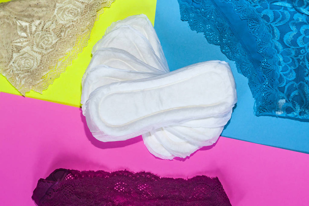 Sanitary pads and female panties. Medicine, women health and ovulation concept. Copy space - Photo, Image