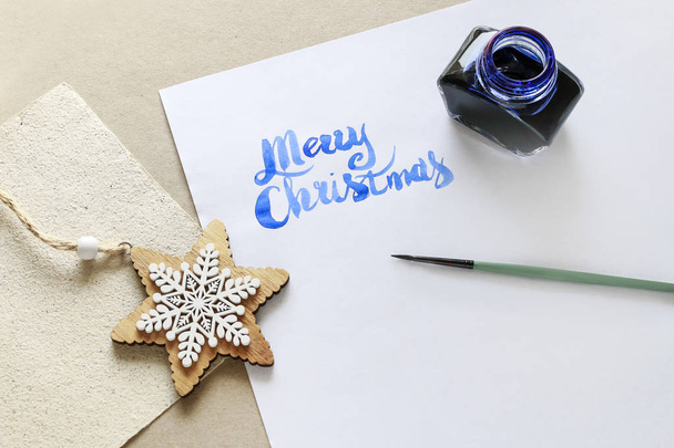 Merry Christmas - calligraphy, handwritten letters on white pape - Fotoğraf, Görsel