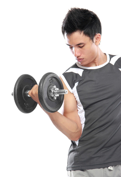 Handsome young man lifting weight - Фото, изображение