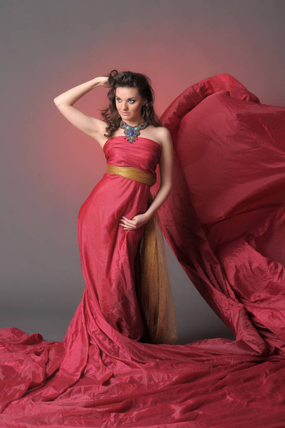 Elegant Fashion Model in Fluttering Red Gown - Fotoğraf, Görsel