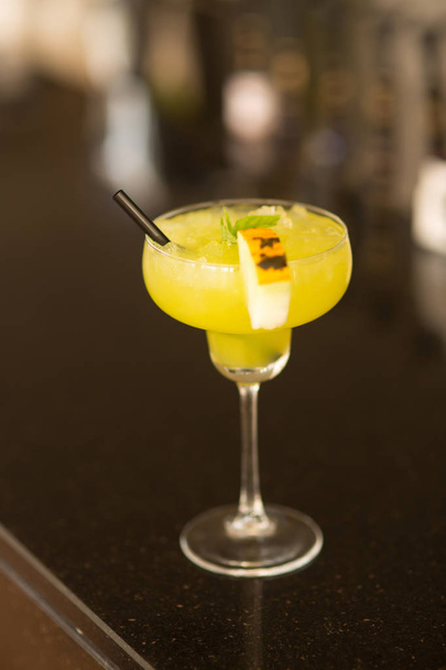 Coctail on the table. Yellow coctail with melon - 写真・画像