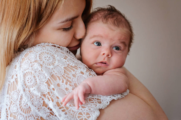 Young beautiful mother with her newborn baby girl - Zdjęcie, obraz