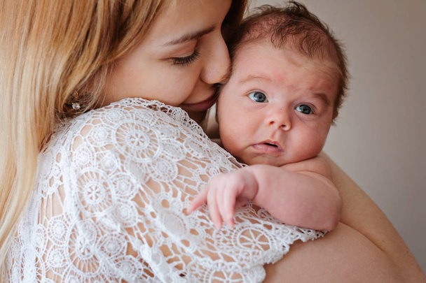Young beautiful mother with her newborn baby girl - Valokuva, kuva