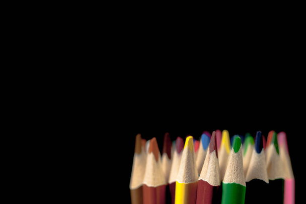 Grouping of colored pencils vertically on black background. Back to school. - Photo, Image