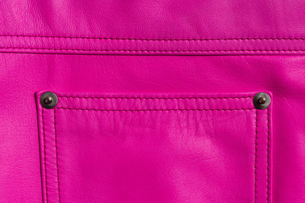 Pink leather skirt. Stitched pocket on rivets. Closeup texture. - Foto, Bild