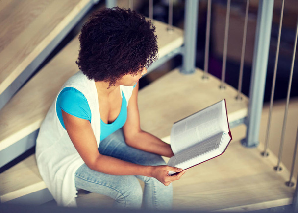 african student girl reading book at library - Valokuva, kuva