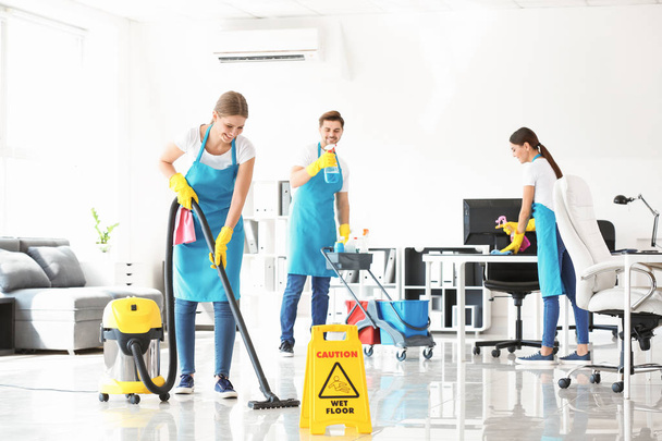 Team of janitors cleaning office - Foto, imagen